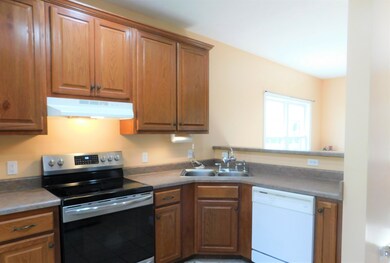 A view of the kitchen from Coffee Bar. Notice the bar for easy serving. Very open for entertaining and communicating with family & friends.