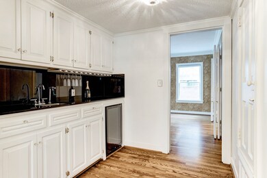 A well-equipped butler's pantry with wine fridge is centrally located with access to/from kitchen, dining room and living room.