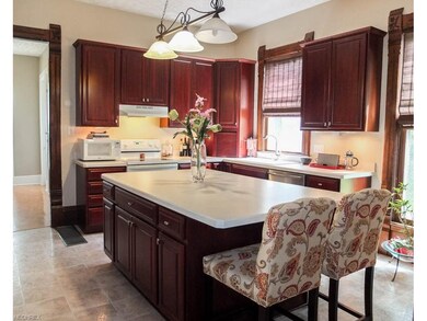 Kitchen has a large center island with breakfast b
