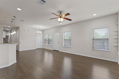 Unfurnished living room featuring a ceiling fan, 