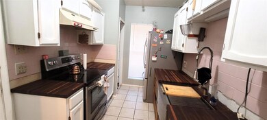 Galley kitchen with butcher block counter tops.