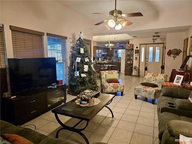 Living area with light tile patterned flooring, ceiling fan, and healthy amount of natural light