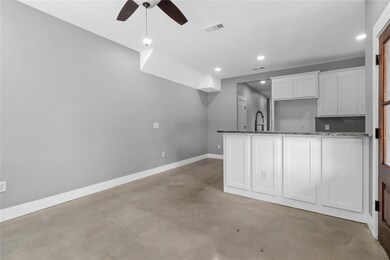 Kitchen featuring a sink, dark stone countertops, 
