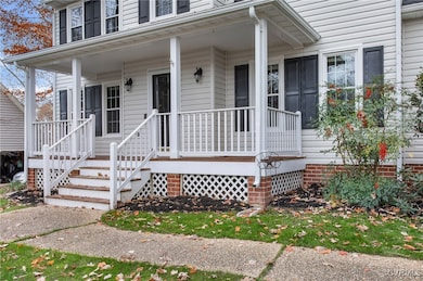View of exterior entry with covered porch