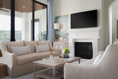 Living area featuring a glass covered fireplace a