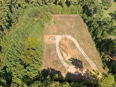 View of property location with a heavily wooded area