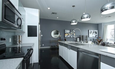 Modern kitchen with stainless steel appliances.