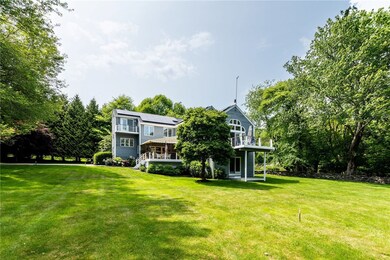 East elevation of the home showing multiple decks and balcony
