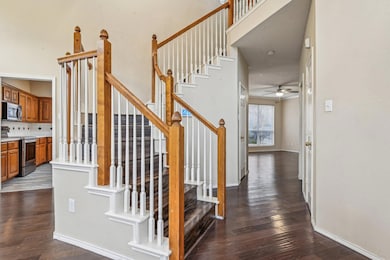 Stairway with ceiling fan, a towering ceiling, woo