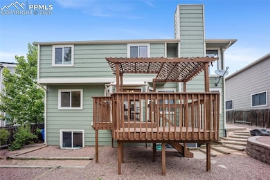 Rear view of property with a chimney and a deck