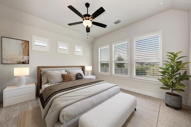 Enjoy peace and privacy with a secluded main floor primary suite overlooking the backyard and greenbelt. (photo virtually staged)