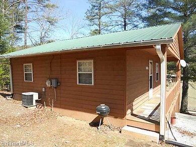 Exterior Front. Exterior front with Side Entrance from Left Side of Home. Photo also shows heat pump