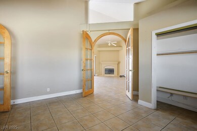 Hallway featuring light tile patterned floors, bas