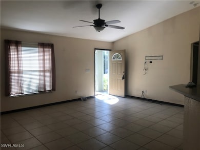 Empty room with a ceiling fan and baseboards