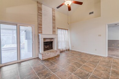 Den with high ceilings, tile floors, ceiling fan a