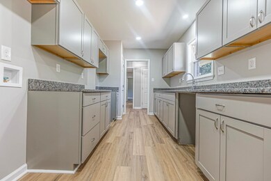 Kitchen featuring gray cabinets and light hardwood