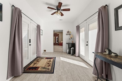 Entrance foyer with french doors, light wood fini