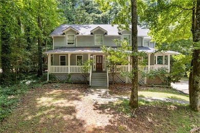 View of front of property featuring a porch and a shingled roof