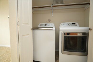 This photo shows a compact laundry area with a mod