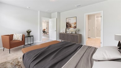 Bedroom featuring baseboards and light carpet