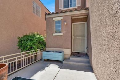Property entrance with stucco siding and a tile ro
