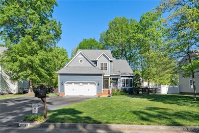 View of front of house featuring aphalt driveway,