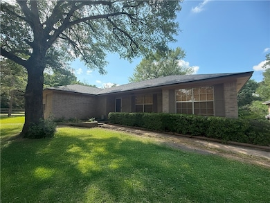 View of front of home with a front yard and brick