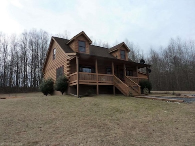 The cabin is located on 1 open acre with 15+ woode