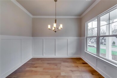 Unfurnished dining area featuring a decorative wal