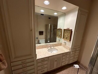 Bathroom with vanity, toilet, an enclosed shower, 