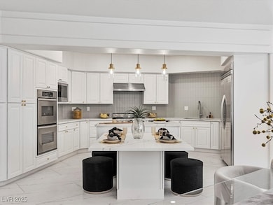 Kitchen with built in appliances, a sink, light ma