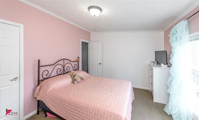 Carpeted bedroom featuring ornamental molding and 