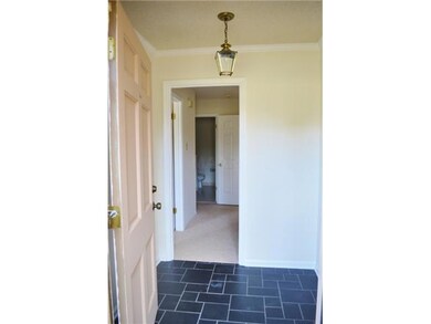Slate floor in entry hall!  Glass storm door to le