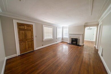 Living room fireplace has marble surround