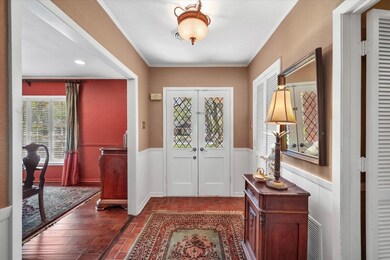 Foyer with french doors and dark wood-type flooring