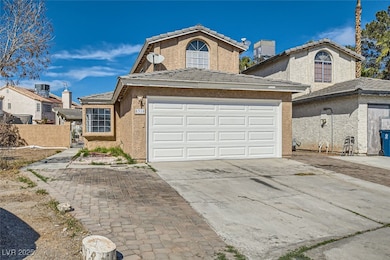 View of front of home featuring driveway, a tile r