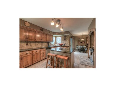 Enjoy the granite counters, tiled backsplash, isla