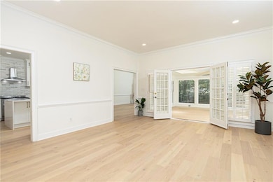 Unfurnished living room with ornamental molding, l