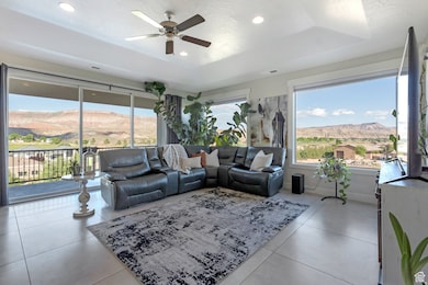 Living room featuring ceiling fan, recessed lighting, and light tile patterned flooring