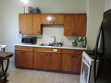 Kitchen featuring sink, black appliances, and ligh
