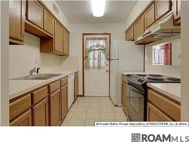 Kitchen leads to private fenced in patio