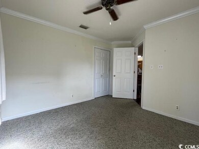 Unfurnished bedroom with crown molding, ceiling fa