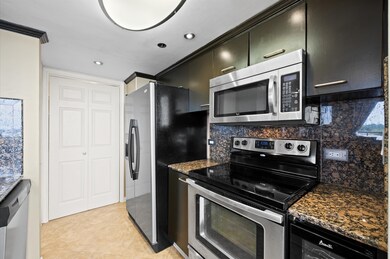 The kitchen features granite countertops, stainles