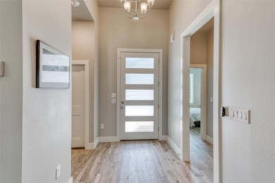 Foyer entrance with light wood-type flooring, bas