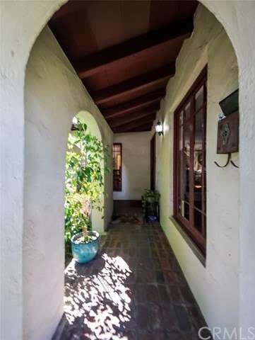 Old brick laid porch and more arches.