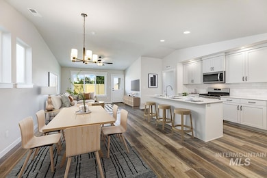 Dining area featuring lofted ceiling, a chandelier, recessed lighting, and dark wood-type flooring