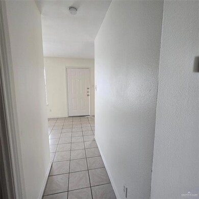 Hallway with light tile patterned floors