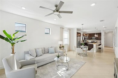Living room with ceiling fan with notable chandeli