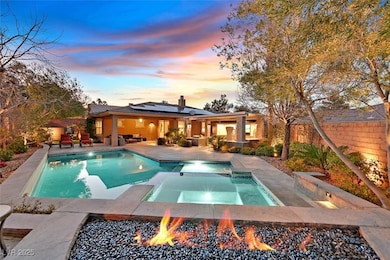 Pool at dusk with raised spa and seating area with