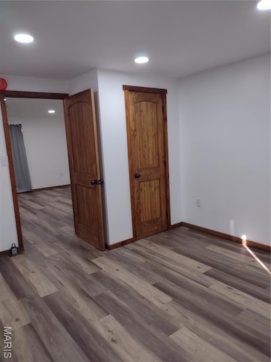 Unfurnished room featuring wood finished floors and recessed lighting